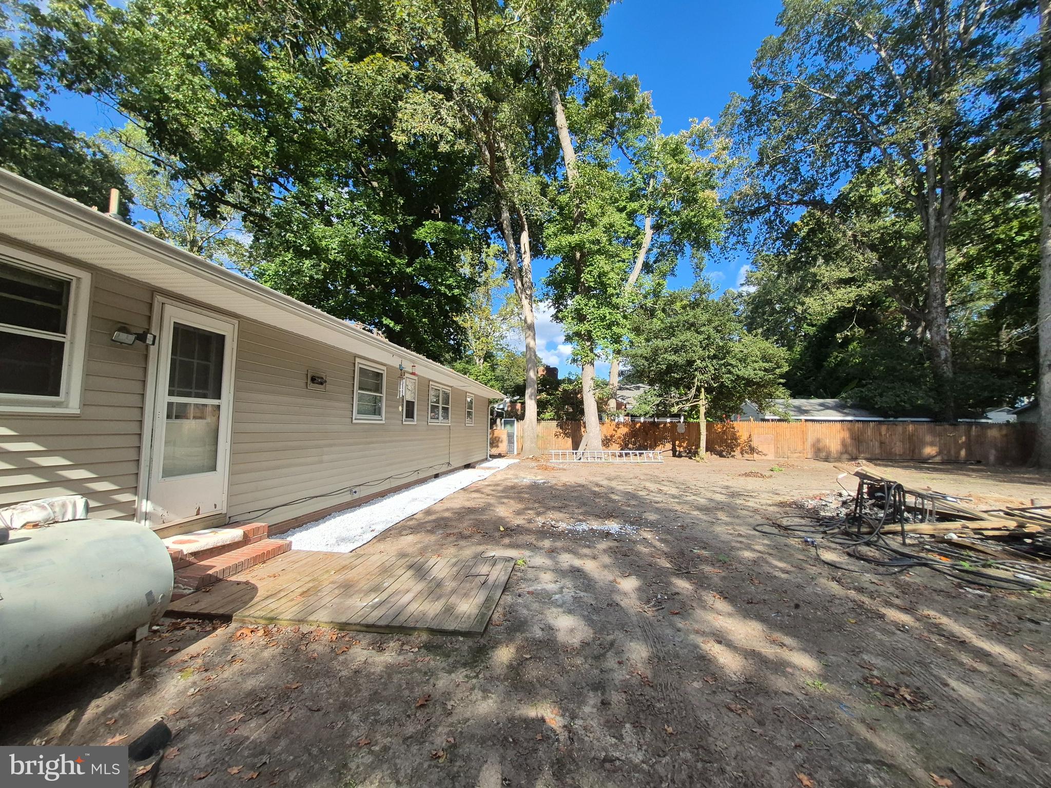 707 West Morris Leonard Road Salisbury, MD 21804 - Photo 22 of 22 a view of backyard with large trees and wooden fence