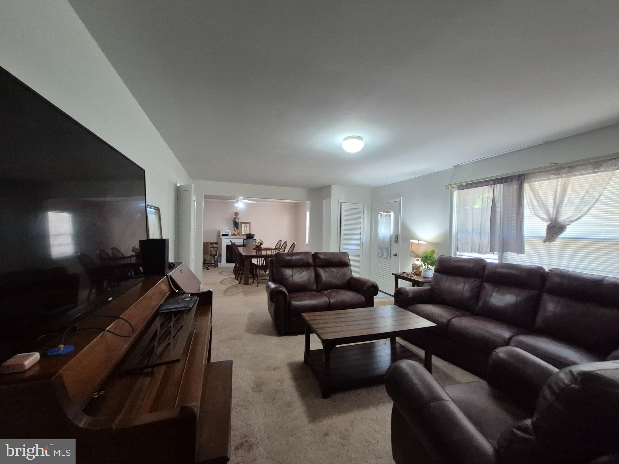 707 West Morris Leonard Road Salisbury, MD 21804 - Photo 3 of 22 a living room with furniture and a flat screen tv
