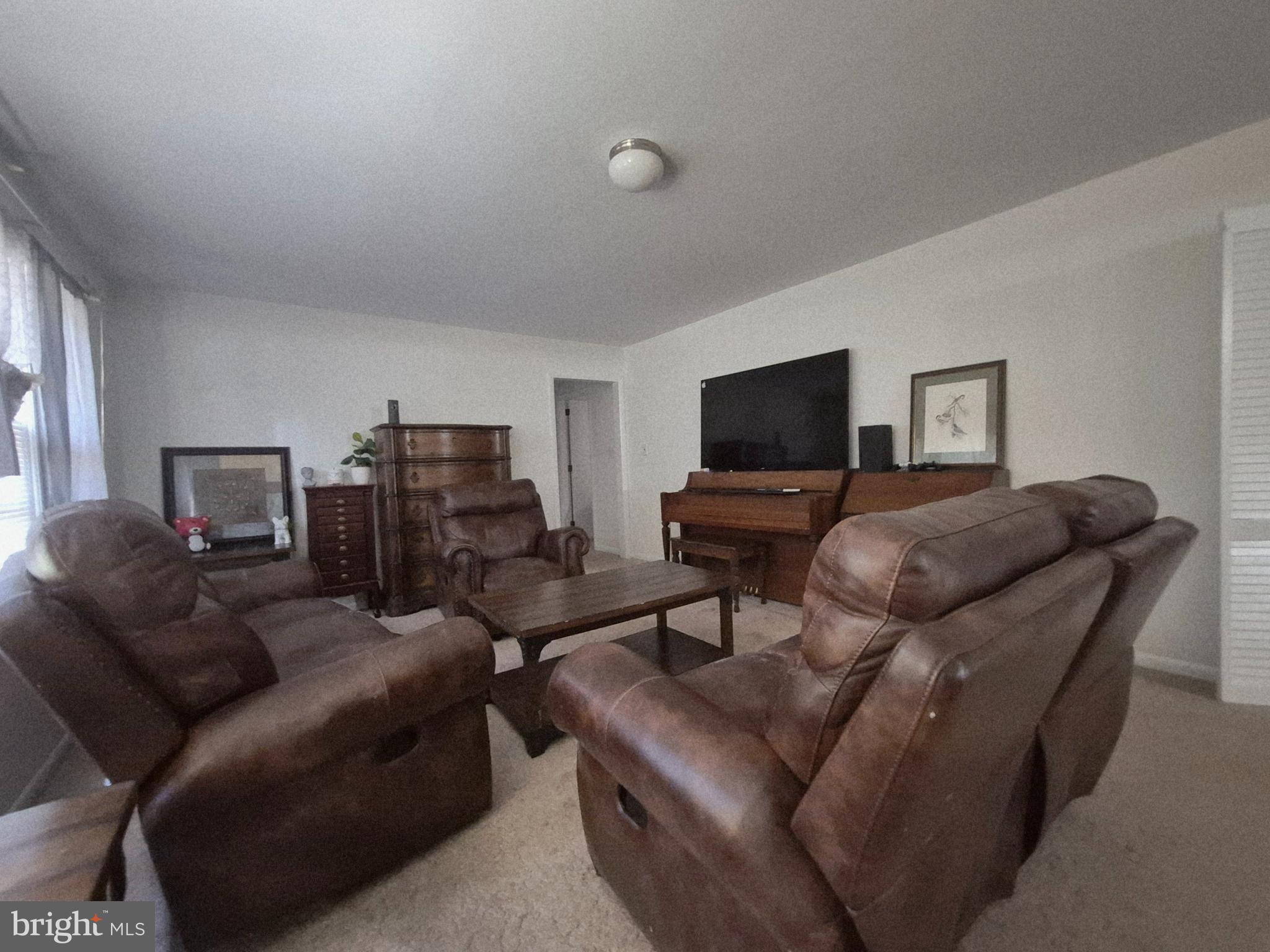 707 West Morris Leonard Road Salisbury, MD 21804 - Photo 4 of 22 a living room with furniture and a flat screen tv