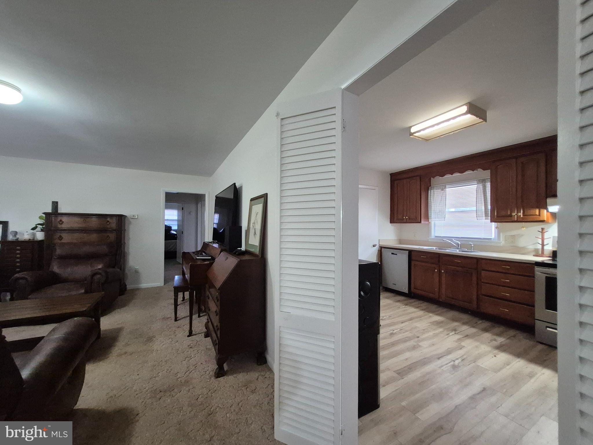 707 West Morris Leonard Road Salisbury, MD 21804 - Photo 5 of 22 a kitchen with stainless steel appliances kitchen island granite countertop a refrigerator and a stove top oven
