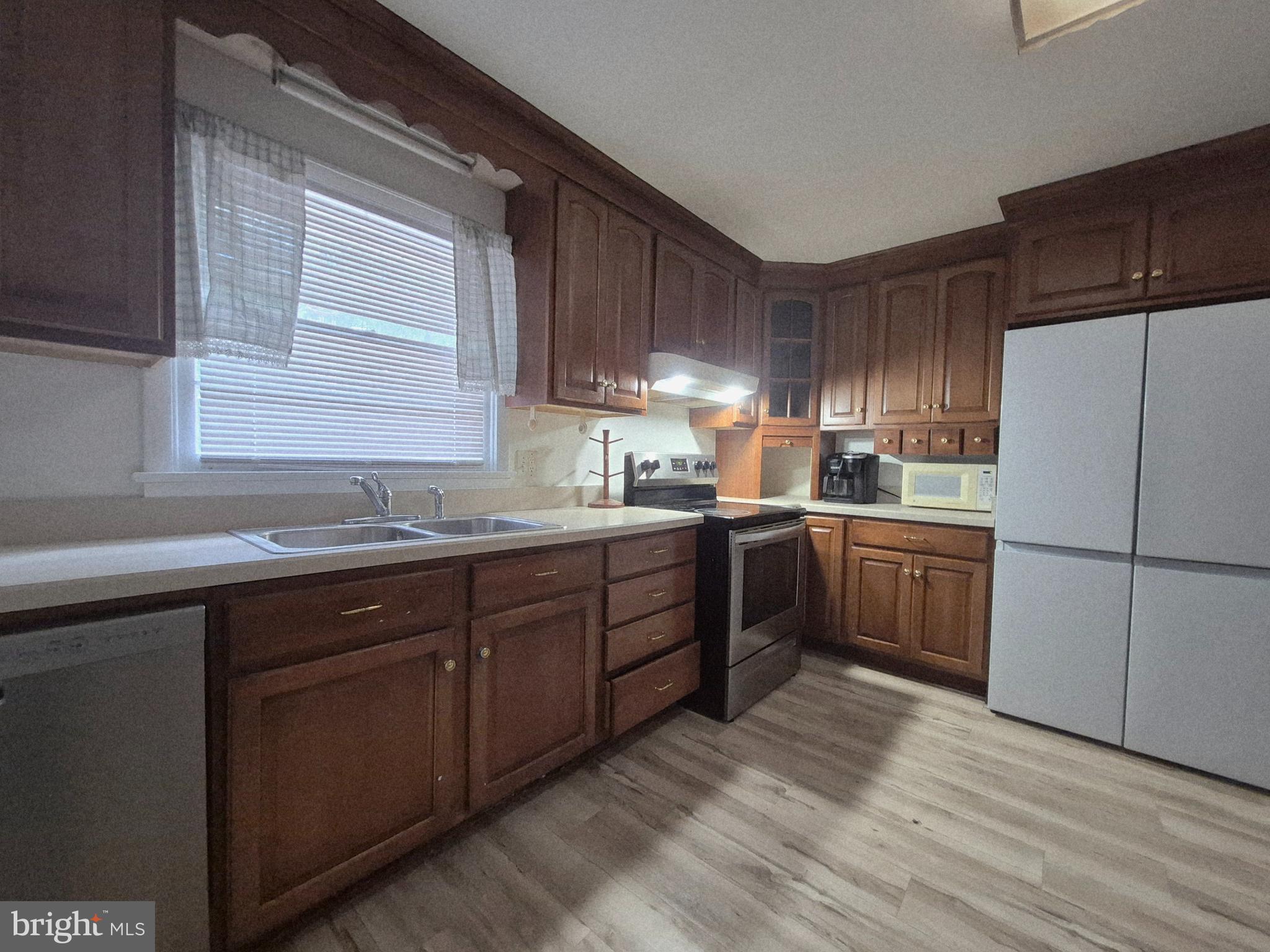 707 West Morris Leonard Road Salisbury, MD 21804 - Photo 8 of 22 a kitchen with a sink a window and stainless steel appliances