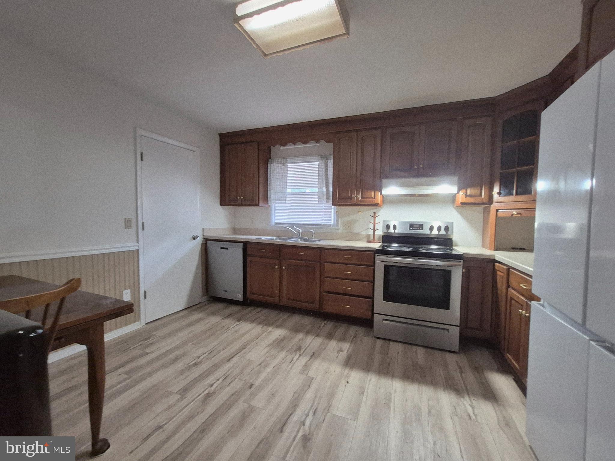707 West Morris Leonard Road Salisbury, MD 21804 - Photo 9 of 22 a kitchen with a sink and a stove top oven
