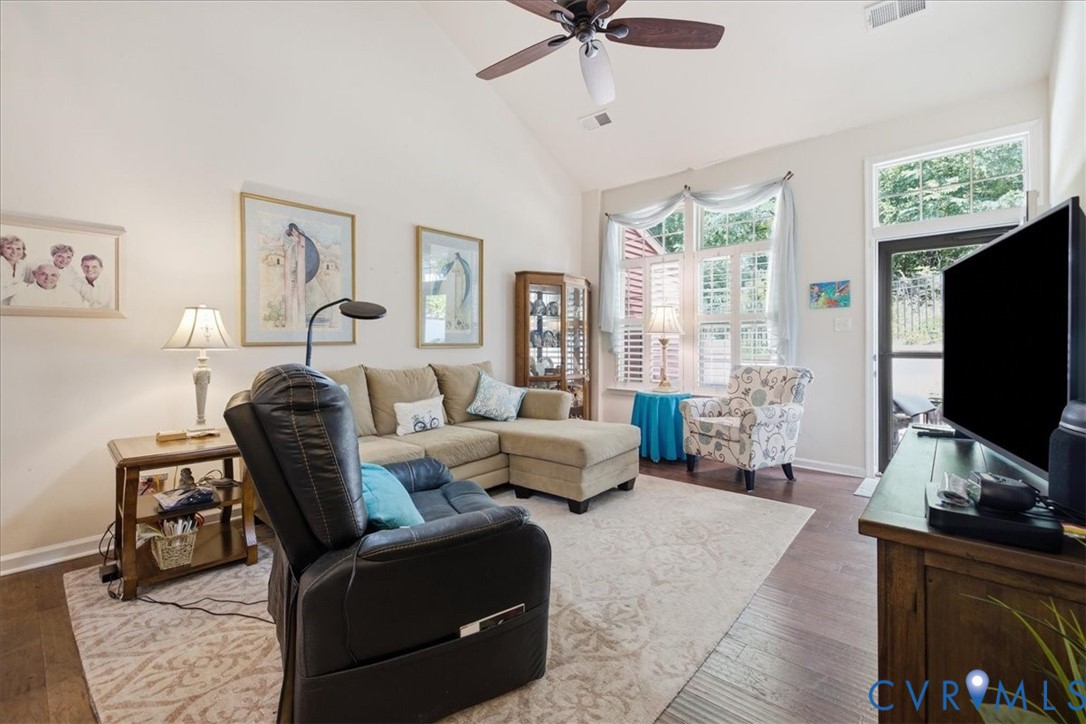 5716 Riverside Place Richmond, VA 23225 - Photo 15 of 33 Vaulted ceiling with a ceiling fan, wood-finish fl