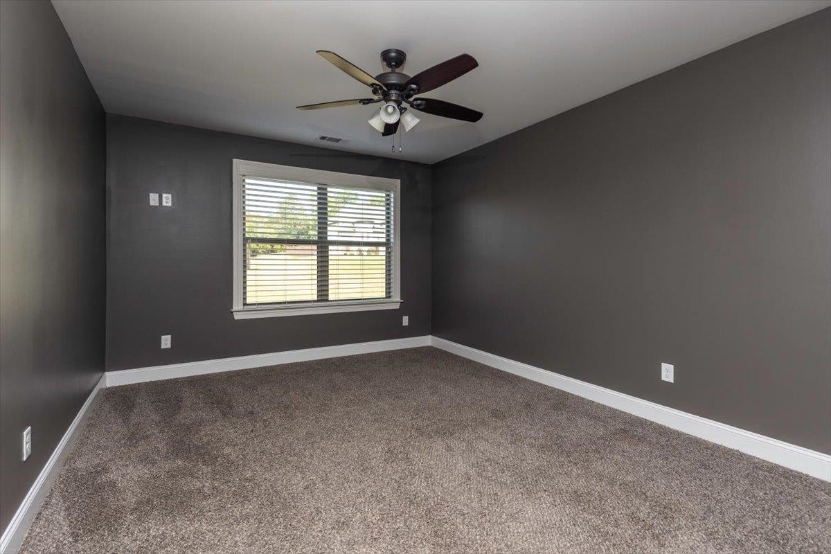 3328 Straw Bridge Road Olive Branch, MS 38654 - Photo 27 of 28 Plush carpeting, a ceiling fan with integrated lighting, a window with blinds, and neutral wall tones