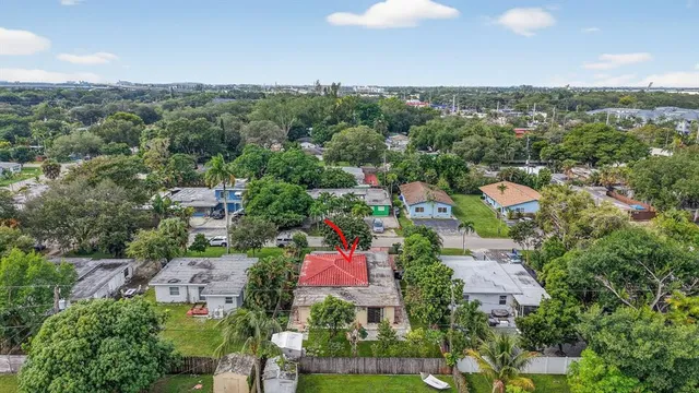 an aerial view of residential houses with outdoor space and city view