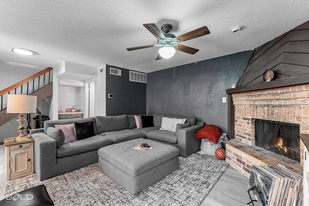 3100 Fairfield Avenue, Unit 10D Shreveport, LA 71104 - Photo 11 of 28 a living room with furniture and a fireplace