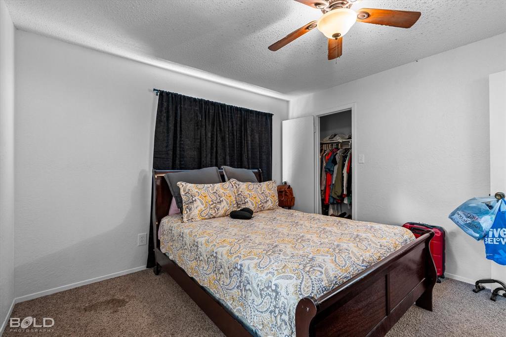 3100 Fairfield Avenue, Unit 10D Shreveport, LA 71104 - Photo 25 of 28 a bed sitting in a bedroom next to a cabinet