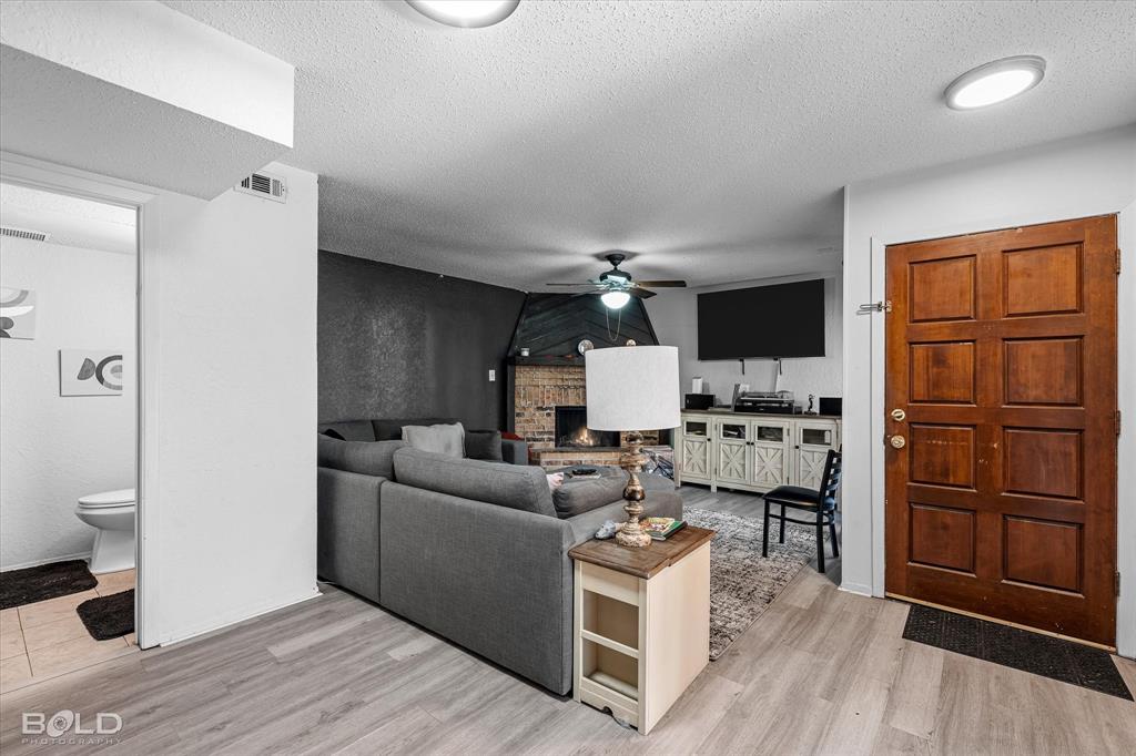 3100 Fairfield Avenue, Unit 10D Shreveport, LA 71104 - Photo 8 of 28 a living room with furniture and a wooden floor