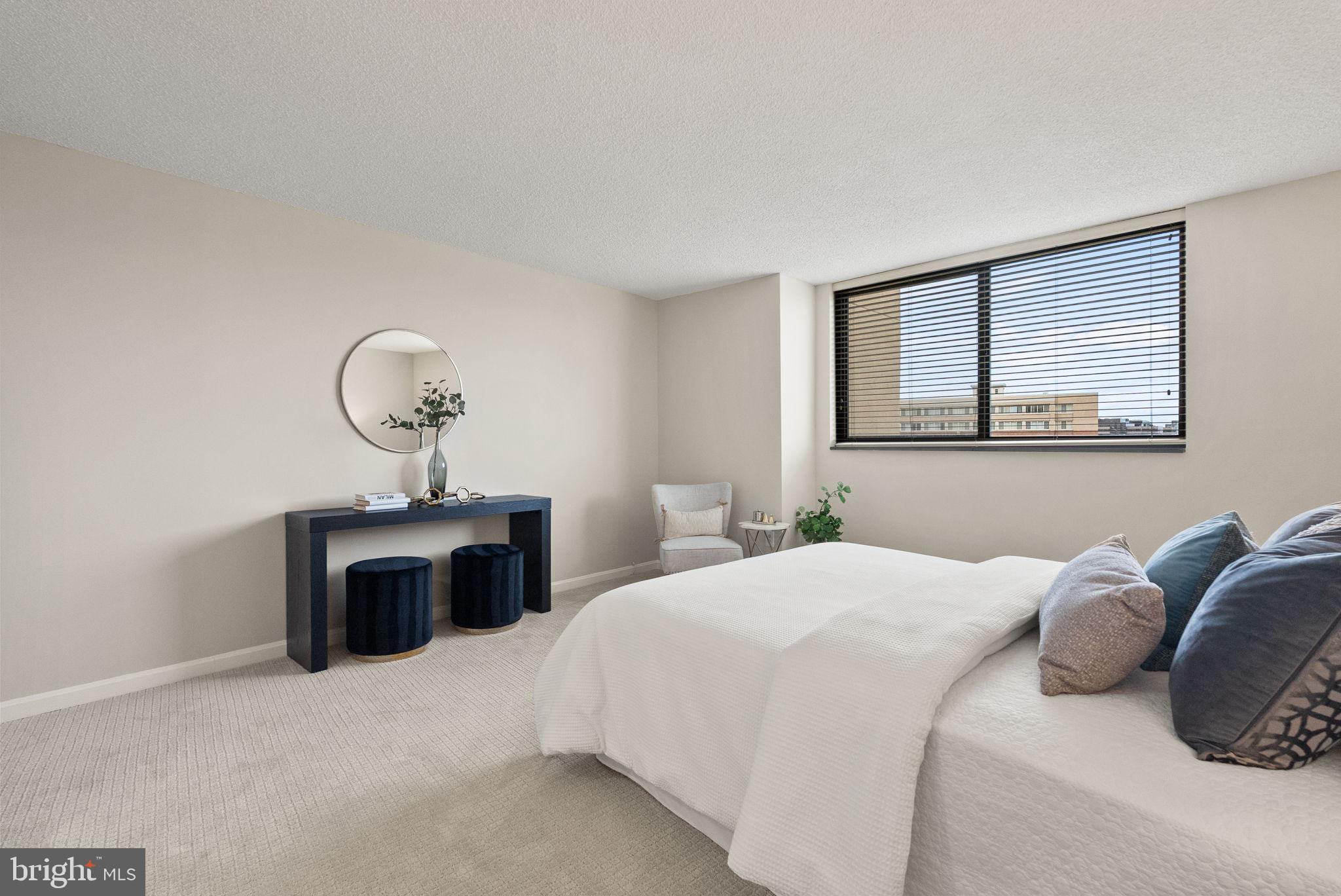 1101 South Arlington Ridge Road, Unit 313 Arlington, VA 22202 - Photo 16 of 59 a bedroom with a bed and a table