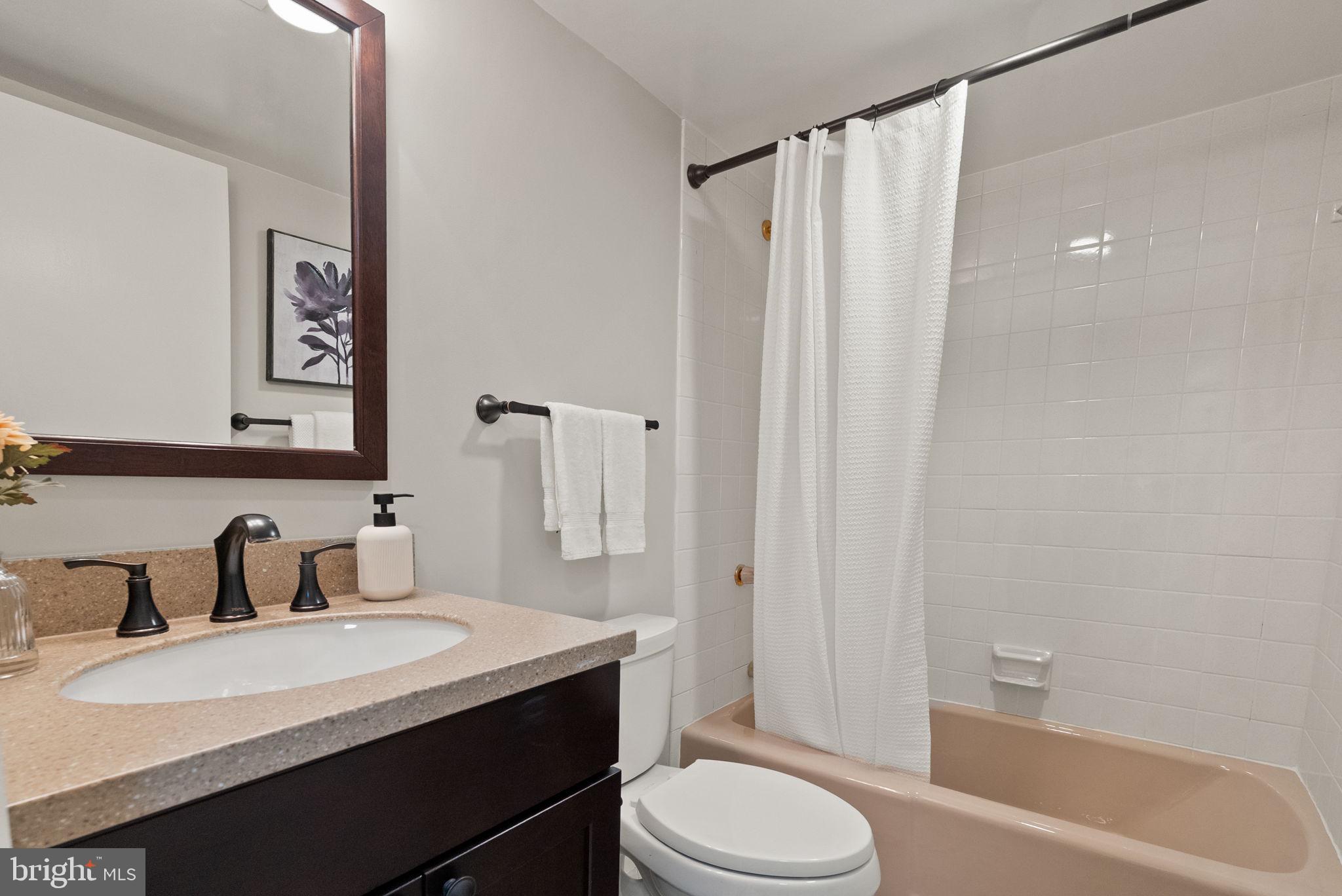 1101 South Arlington Ridge Road, Unit 313 Arlington, VA 22202 - Photo 25 of 59 a bathroom with a sink a toilet and shower