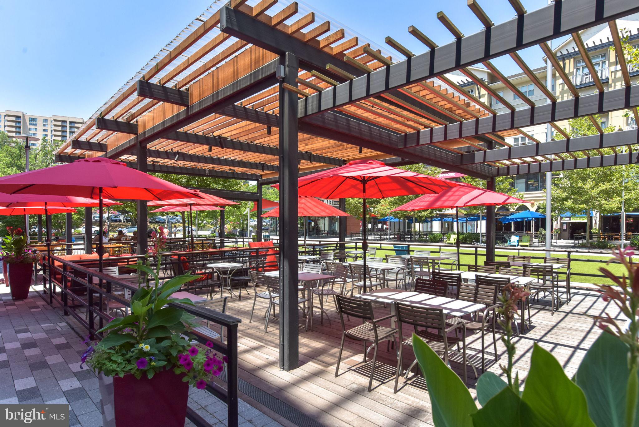1101 South Arlington Ridge Road, Unit 313 Arlington, VA 22202 - Photo 38 of 59 an outdoor space with patio couches table and chairs under an umbrella
