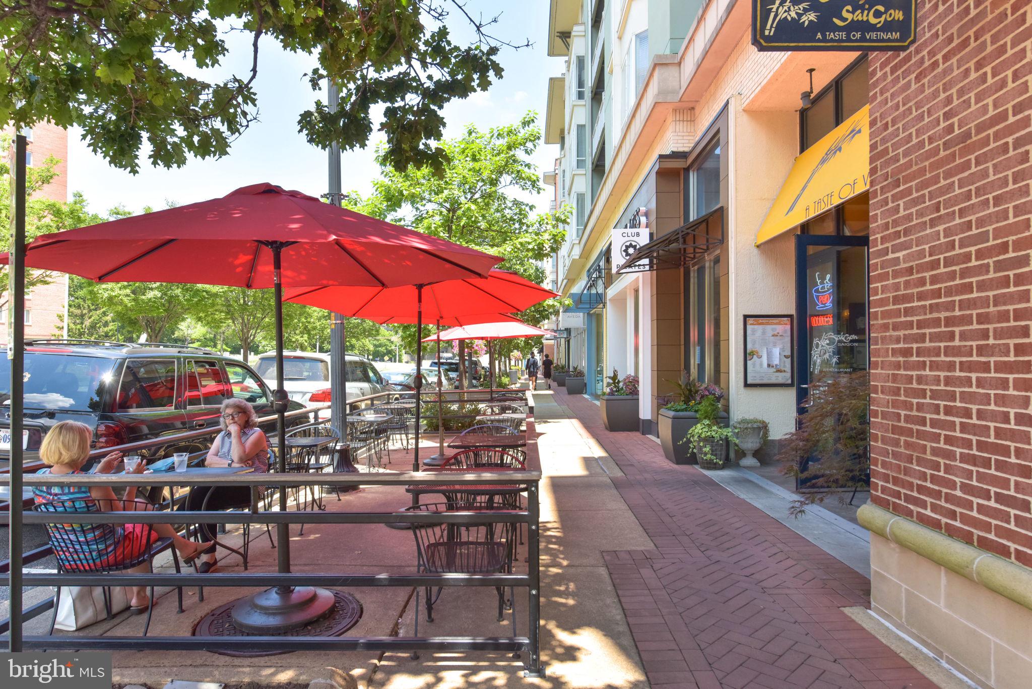 1101 South Arlington Ridge Road, Unit 313 Arlington, VA 22202 - Photo 49 of 59 a view of the patio with chairs and a umbrella