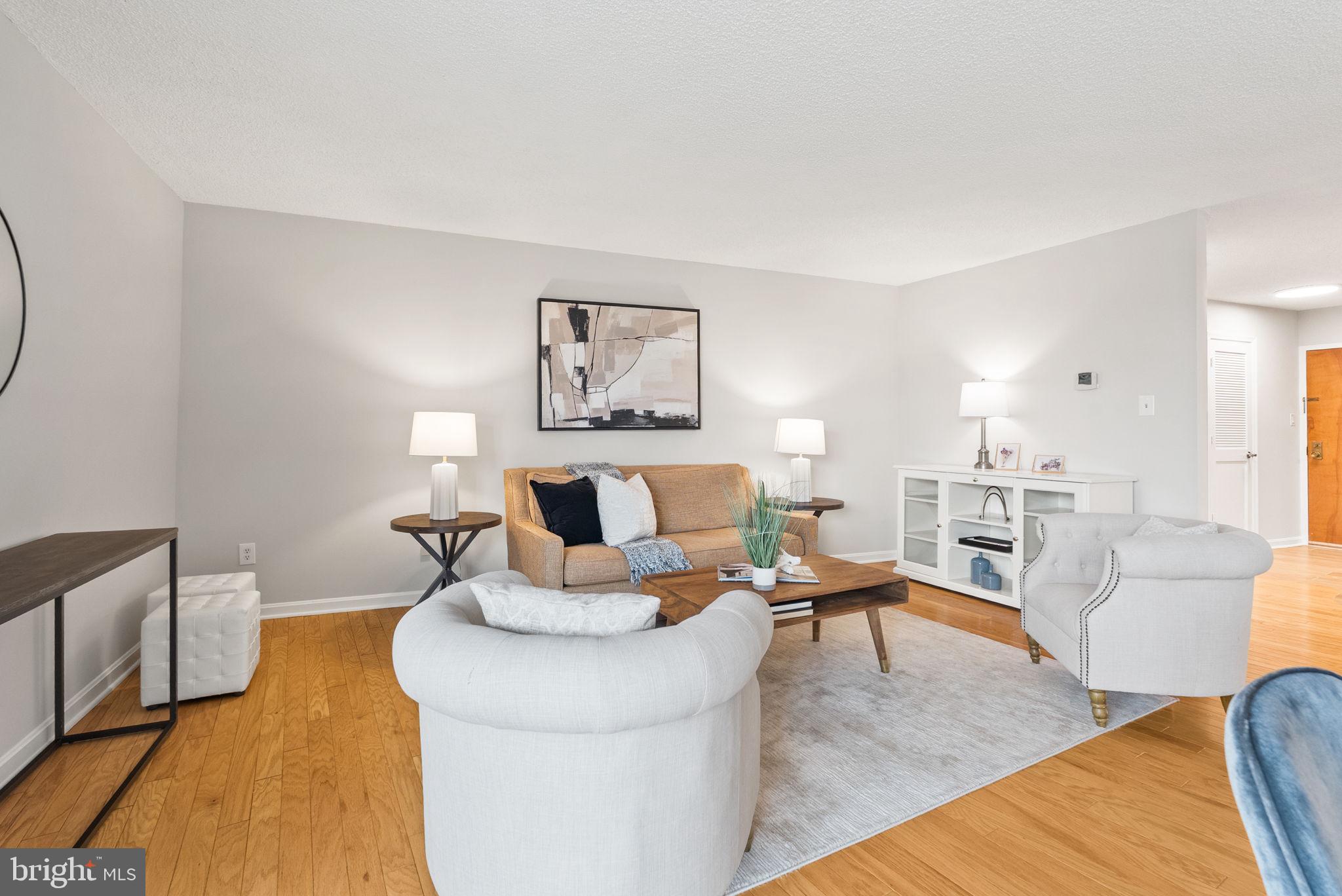 1101 South Arlington Ridge Road, Unit 313 Arlington, VA 22202 - Photo 5 of 59 a living room with furniture and wooden floor