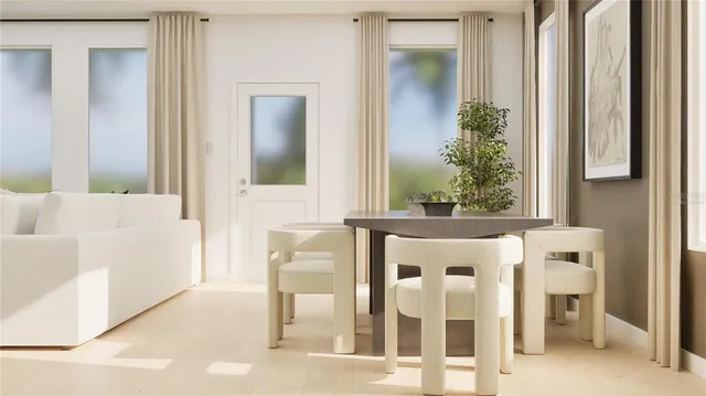 a view of a dining room with furniture and a window