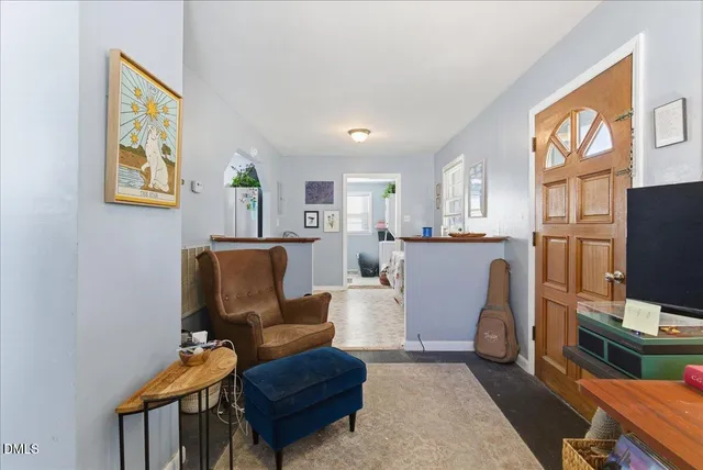 a living room with furniture a rug and a window
