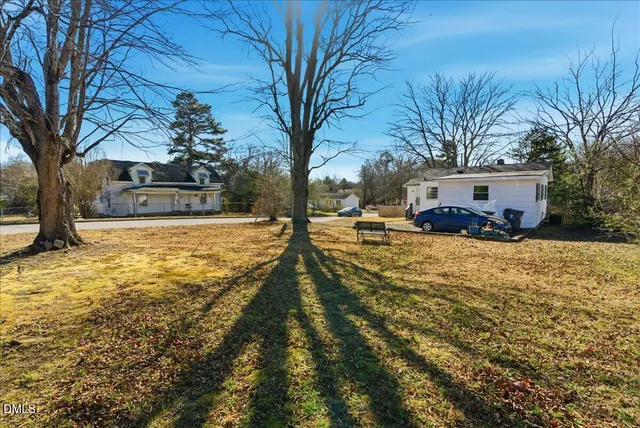 a view of a house with a yard covered in snow