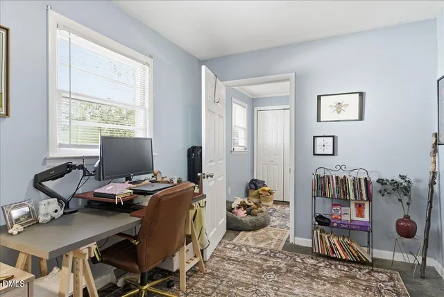 a bedroom with a bed and a dresser in it