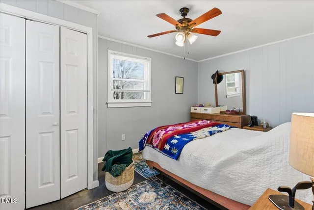 a living room with furniture a flat screen tv and kitchen view