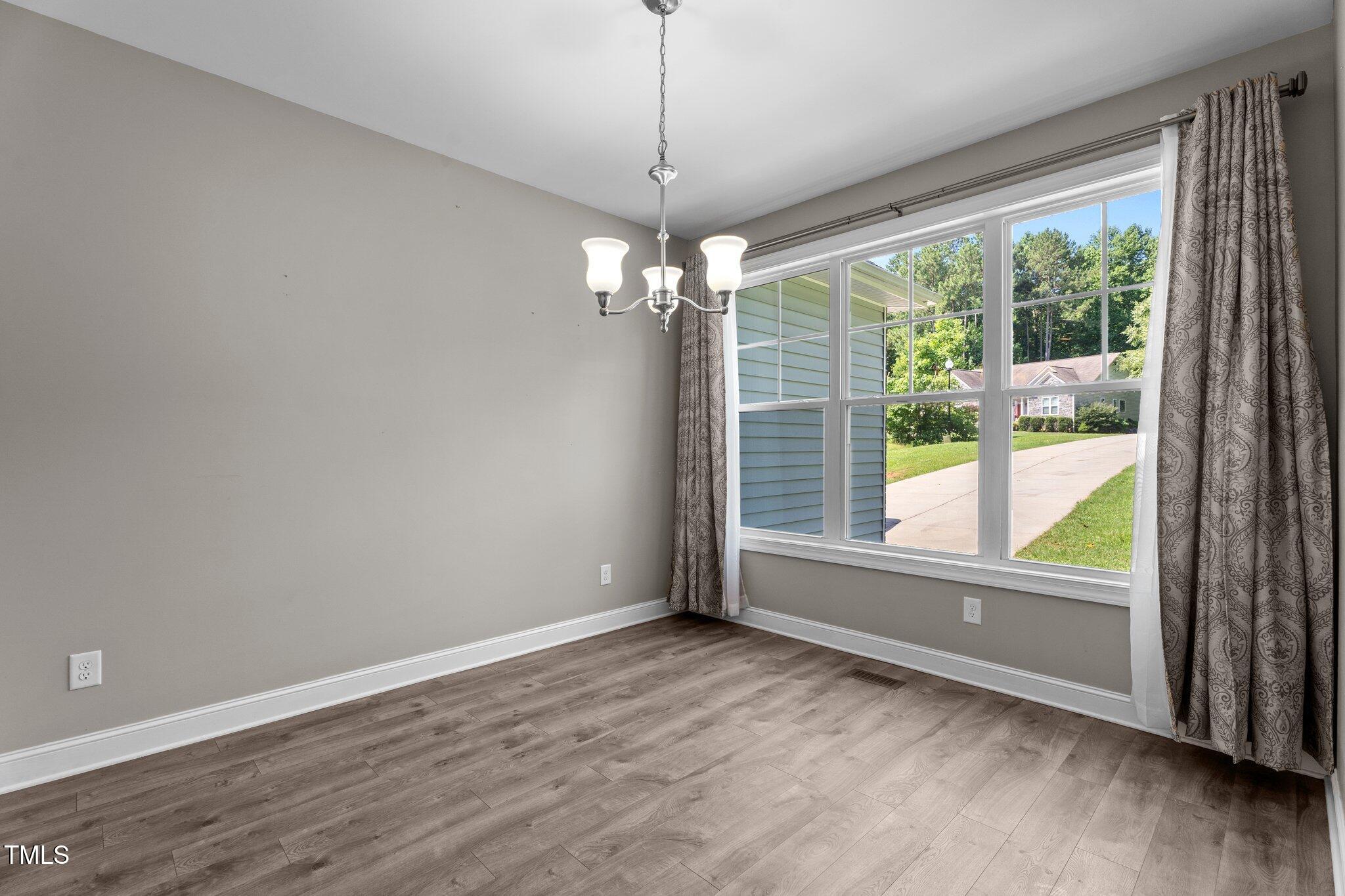46 Trusting Lane Middlesex, NC 27557 - Photo 15 of 35 en empty room with wooden floor and outdoor view