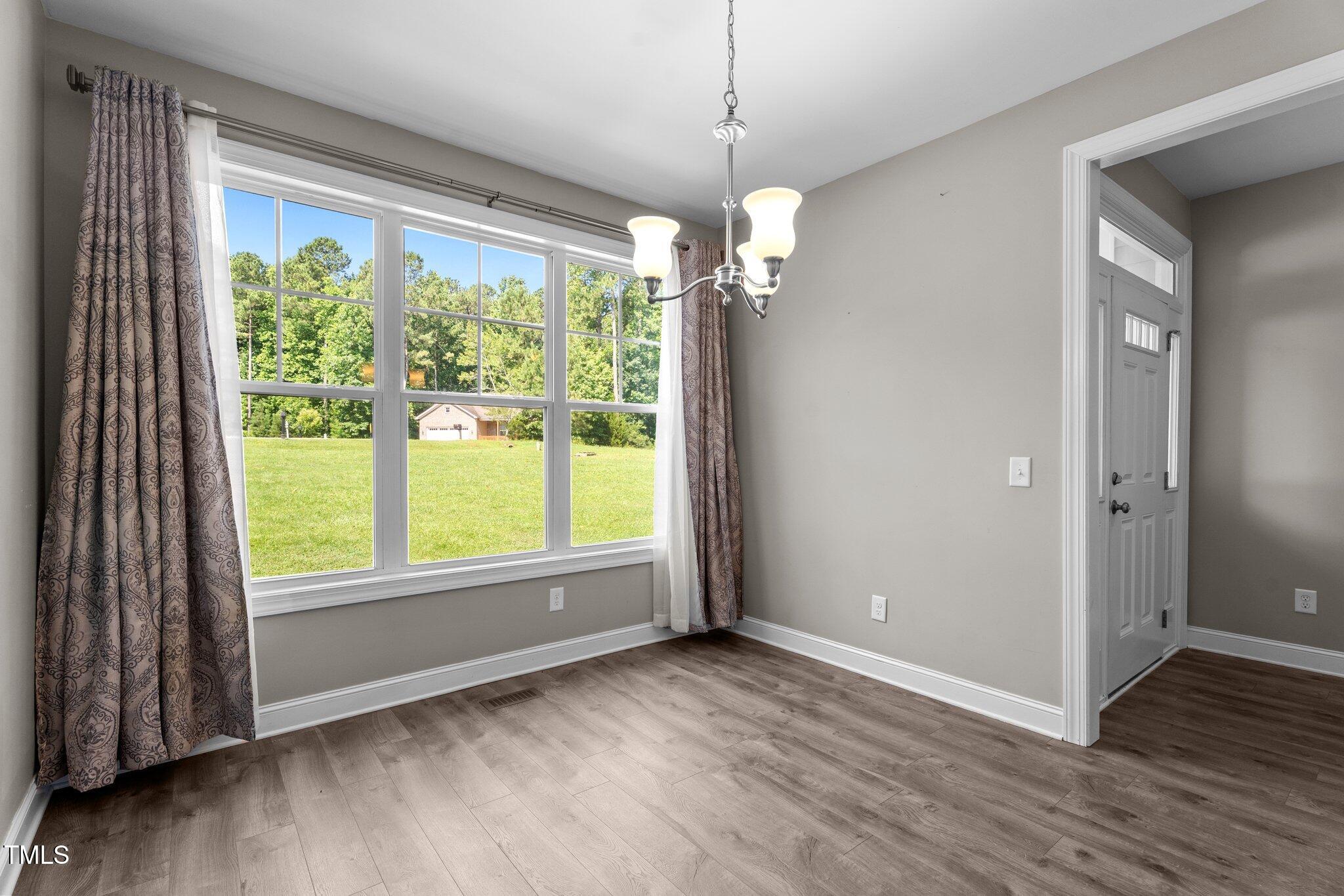46 Trusting Lane Middlesex, NC 27557 - Photo 16 of 35 an empty room with wooden floor and windows