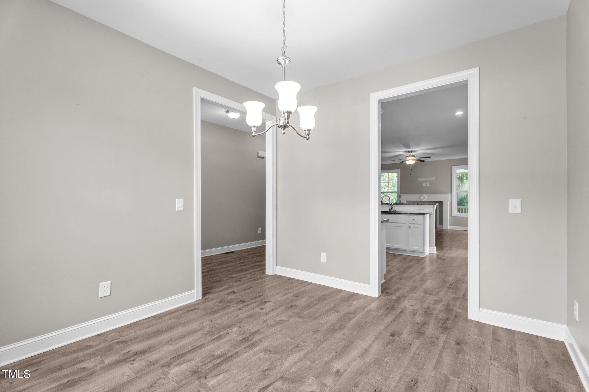 46 Trusting Lane Middlesex, NC 27557 - Photo 17 of 35 wooden floor in an empty room with a kitchen