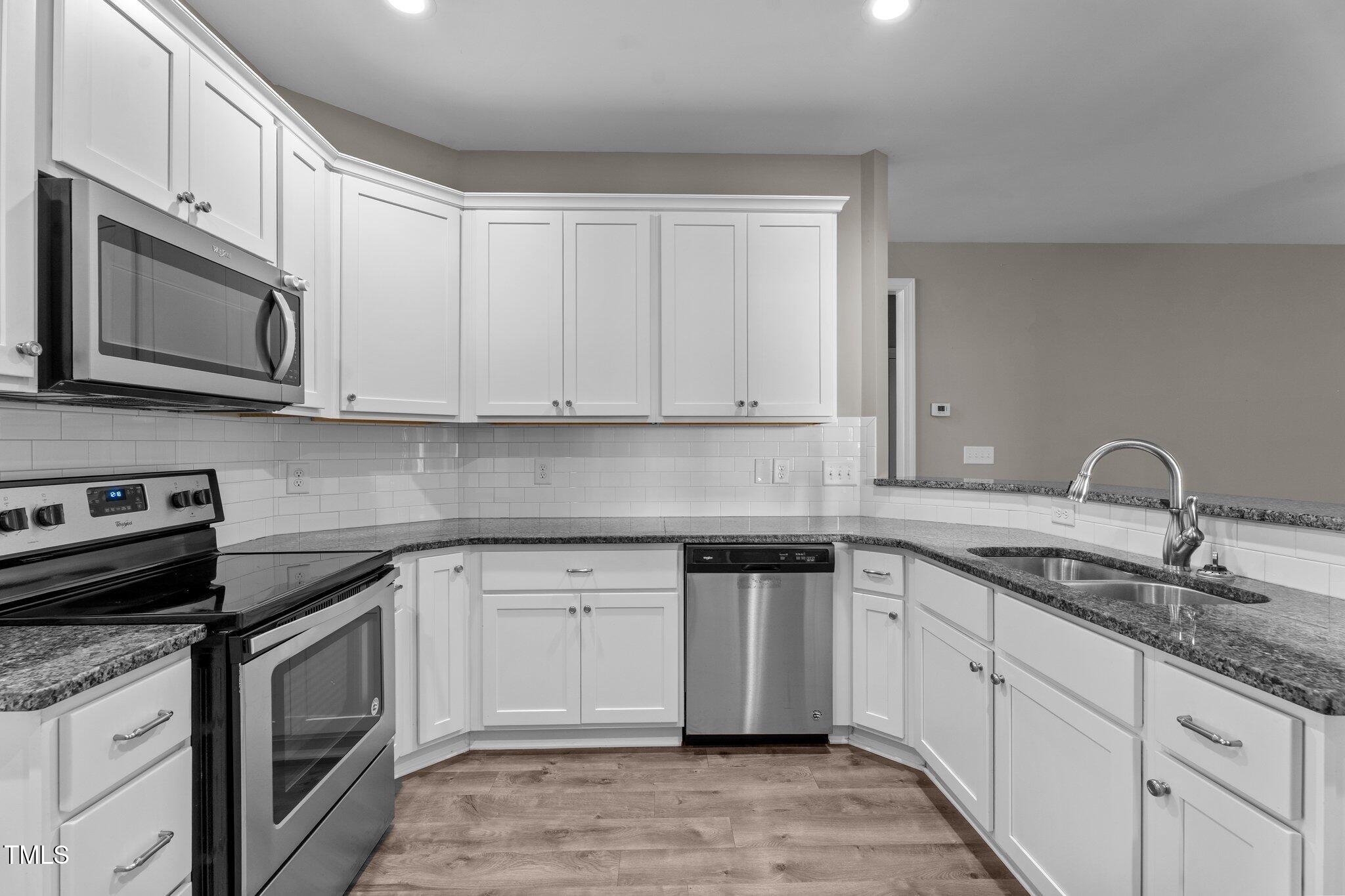 46 Trusting Lane Middlesex, NC 27557 - Photo 21 of 35 a kitchen with stainless steel appliances granite countertop a sink stove and microwave