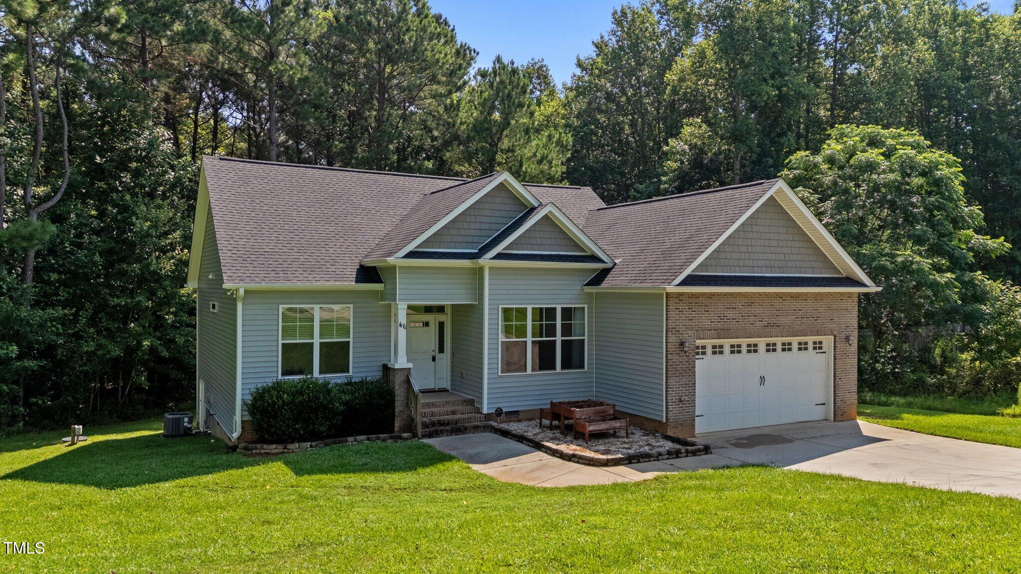 46 Trusting Lane Middlesex, NC 27557 - Photo 4 of 35 a view of a house with garden and trees in the background