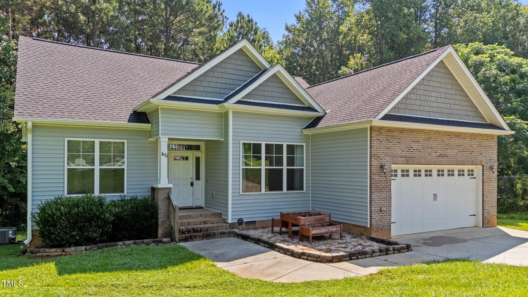 46 Trusting Lane Middlesex, NC 27557 - Photo 5 of 35 a front view of a house with garden