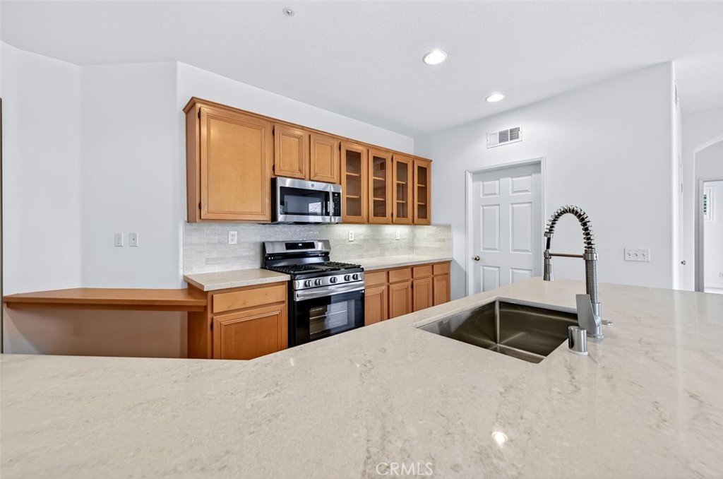 447 Ridgeway Irvine, CA 92620 - Photo 67 of 88 a kitchen with granite countertop a stove top oven and sink