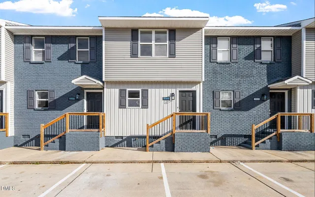 a front view of a house with a road