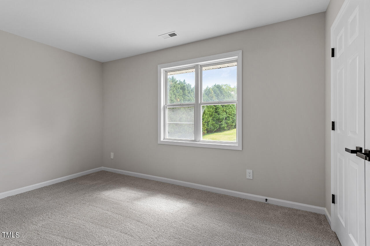 367 East Williams Street Angier, NC 27501 - Photo 23 of 33 an empty room with a window