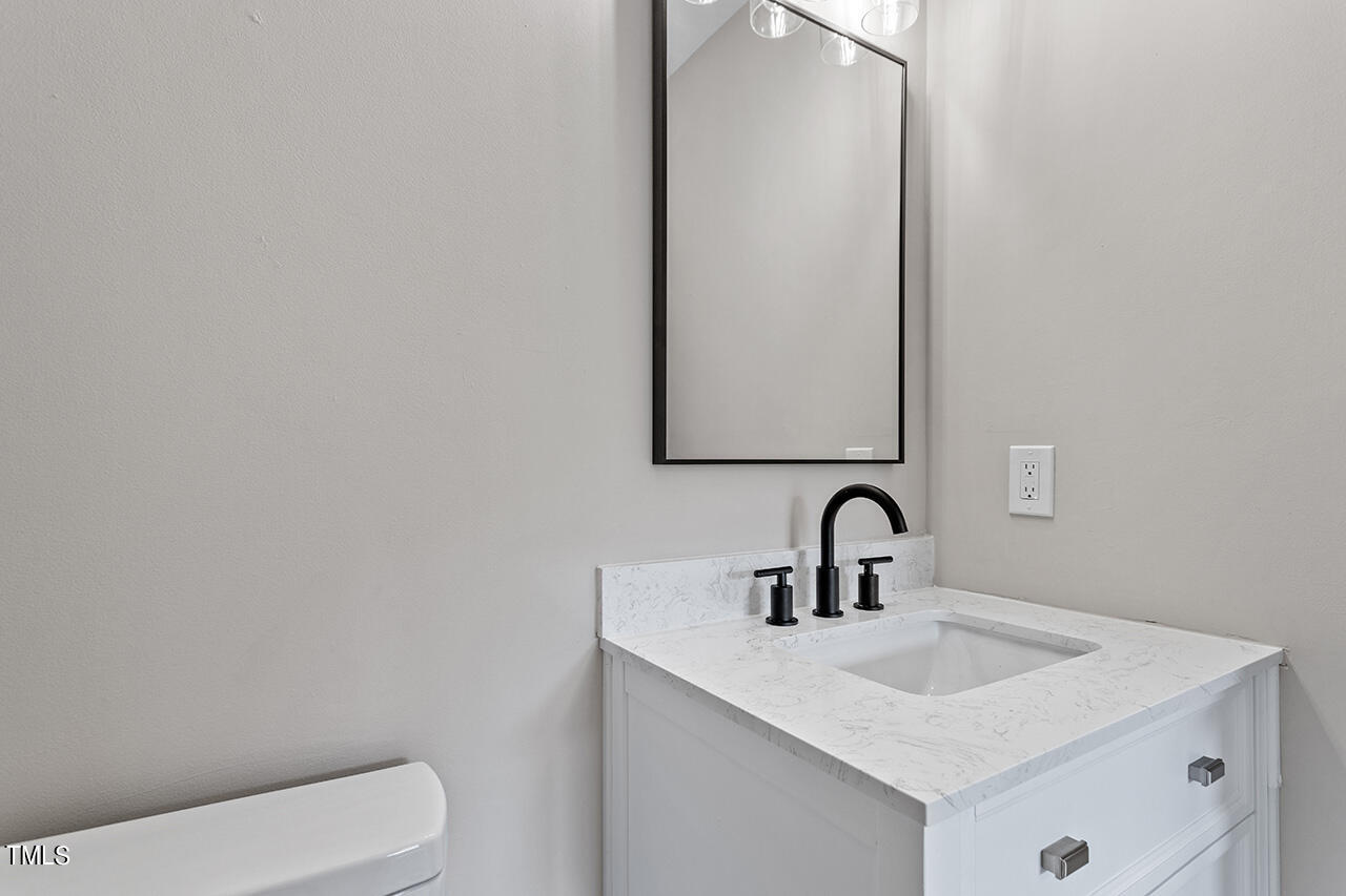 367 East Williams Street Angier, NC 27501 - Photo 28 of 33 a bathroom with a toilet sink and mirror