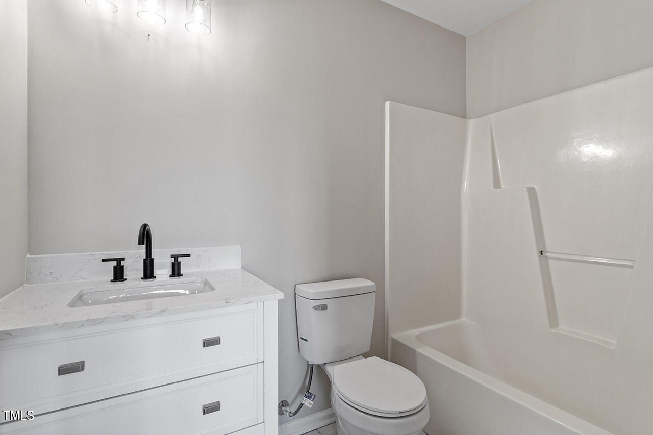 367 East Williams Street Angier, NC 27501 - Photo 29 of 33 a bathroom with a sink a toilet and shower