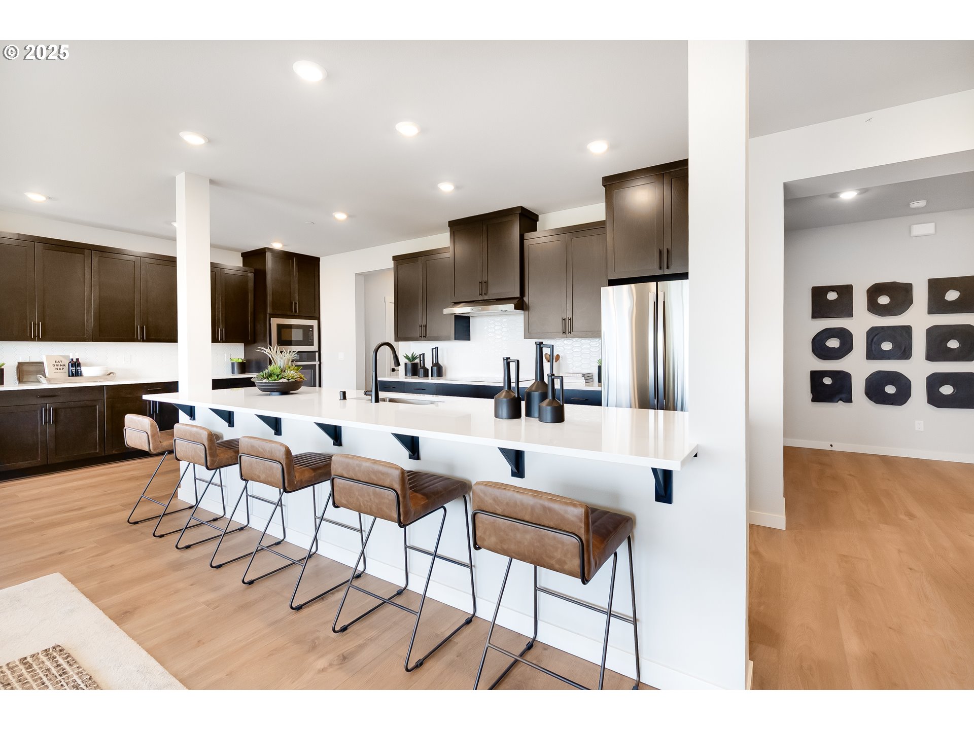 5269 North 87th Avenue Camas, WA 98607 - Photo 11 of 48 a living room with stainless steel appliances kitchen island granite countertop a dining table chairs and a kitchen view