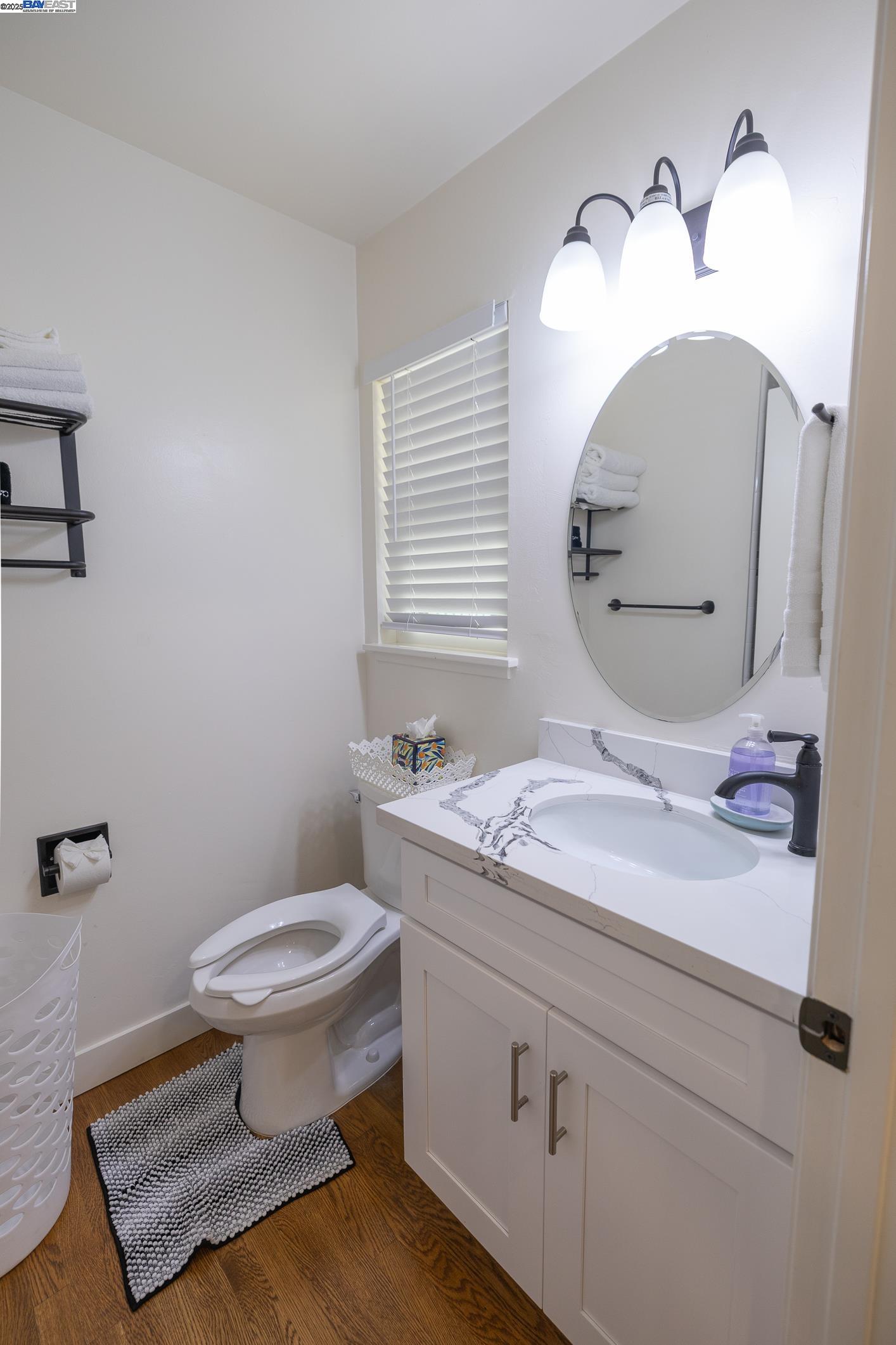 767 Lemos Avenue Salinas, CA 93901 - Photo 25 of 60 a bathroom with a granite countertop toilet sink and mirror