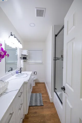 a large kitchen with a sink and refrigerator