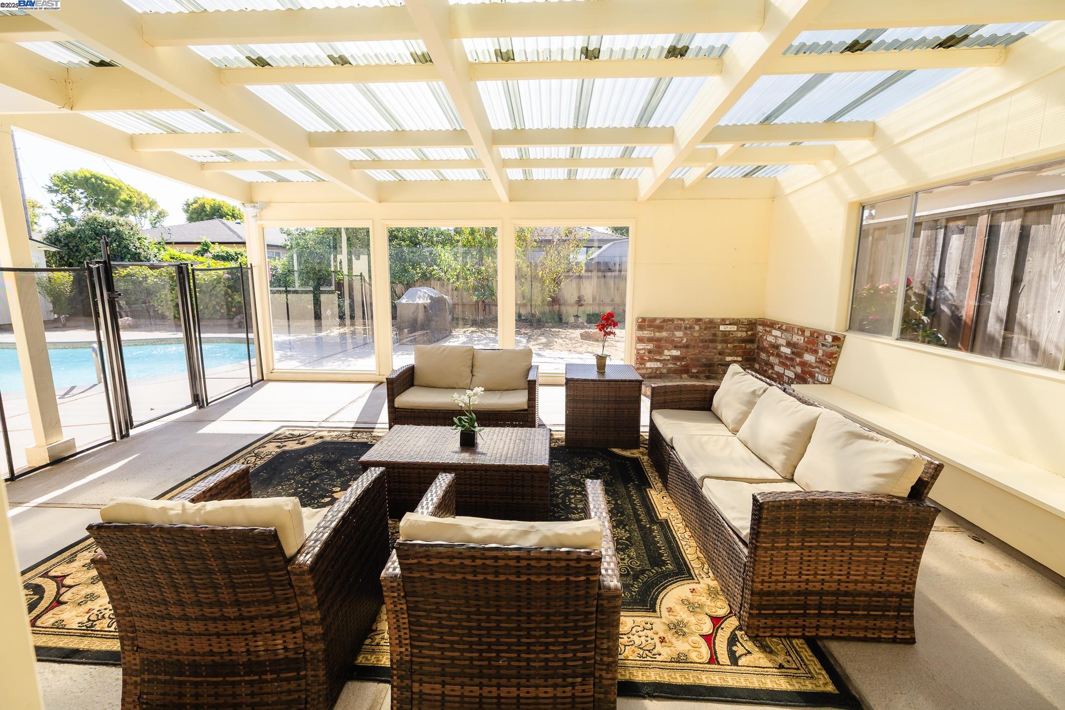 767 Lemos Avenue Salinas, CA 93901 - Photo 40 of 60 a living room with furniture and a floor to ceiling window
