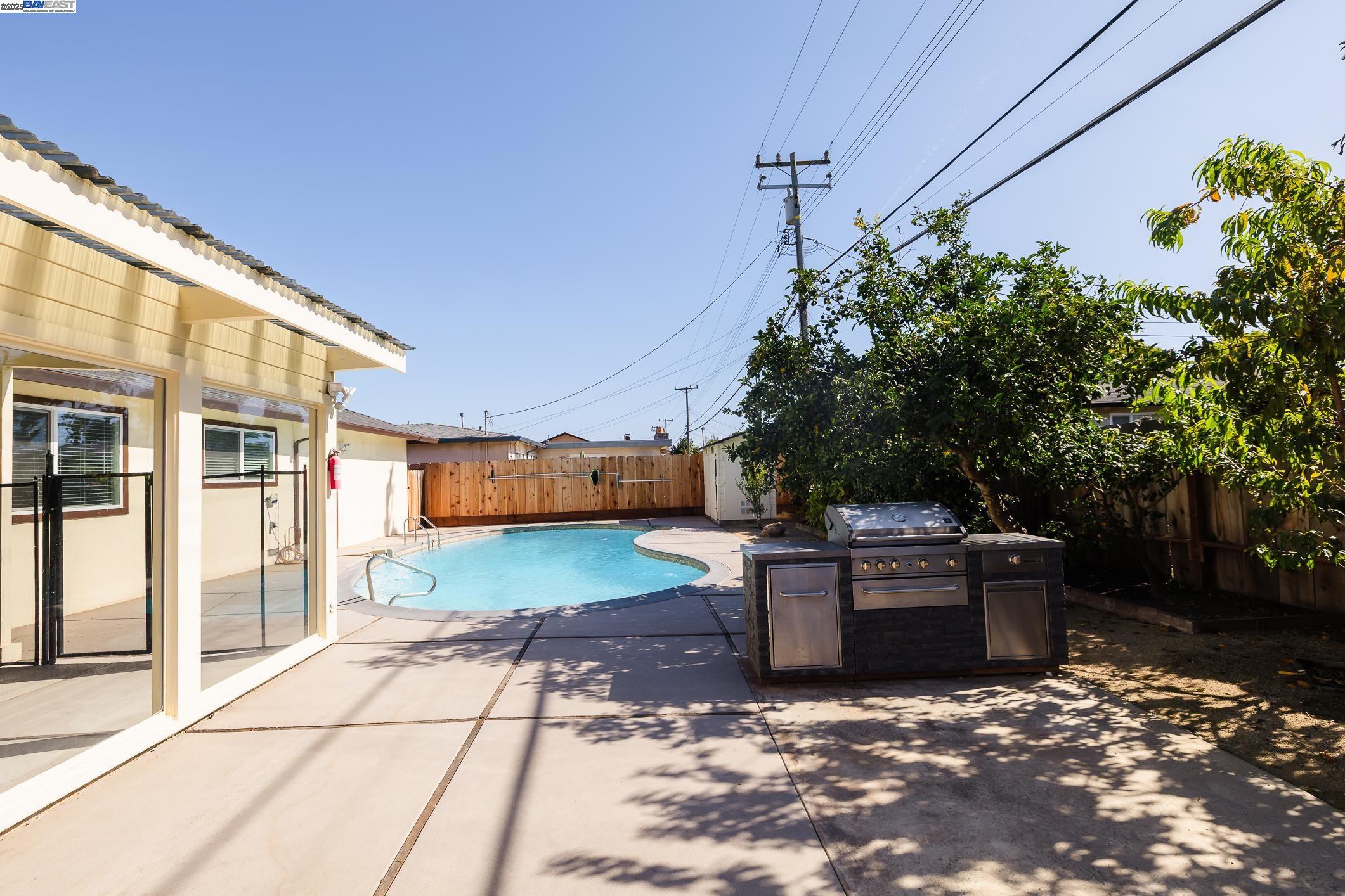 767 Lemos Avenue Salinas, CA 93901 - Photo 46 of 60 Enjoy a true California backyard with a refreshing pool, built-in BBQ island & seamless access to the enclosed sunroom. Ideal for relaxing, hosting or family gatherings, surrounded by fruit trees & generous patio space.