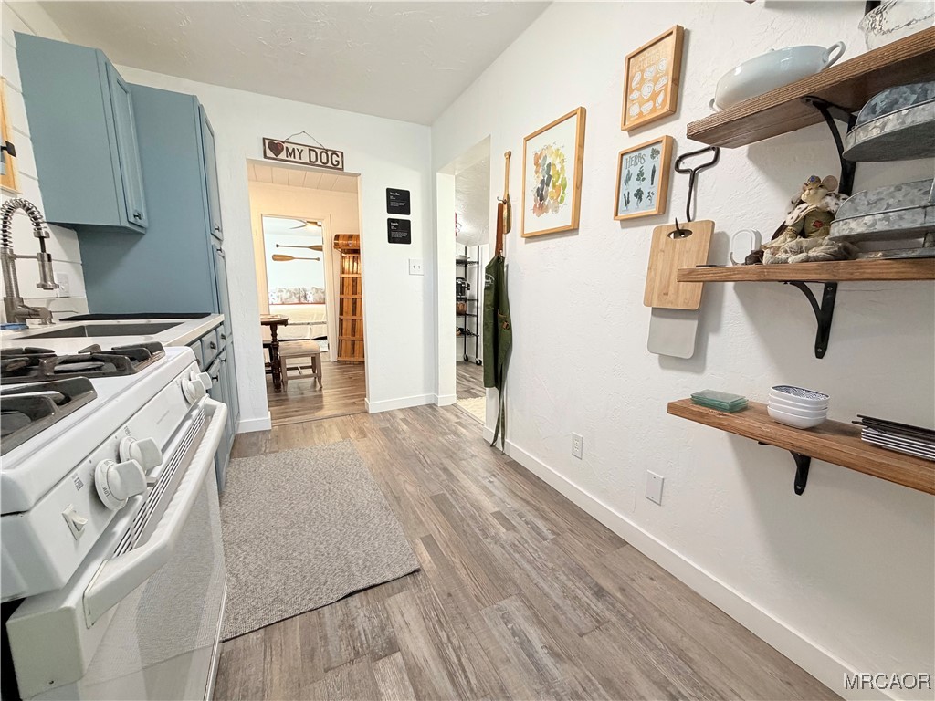 926 Kuffle Canyon Road Skyforest, CA 92385 - Photo 18 of 35 a kitchen with granite countertop a sink stove and refrigerator