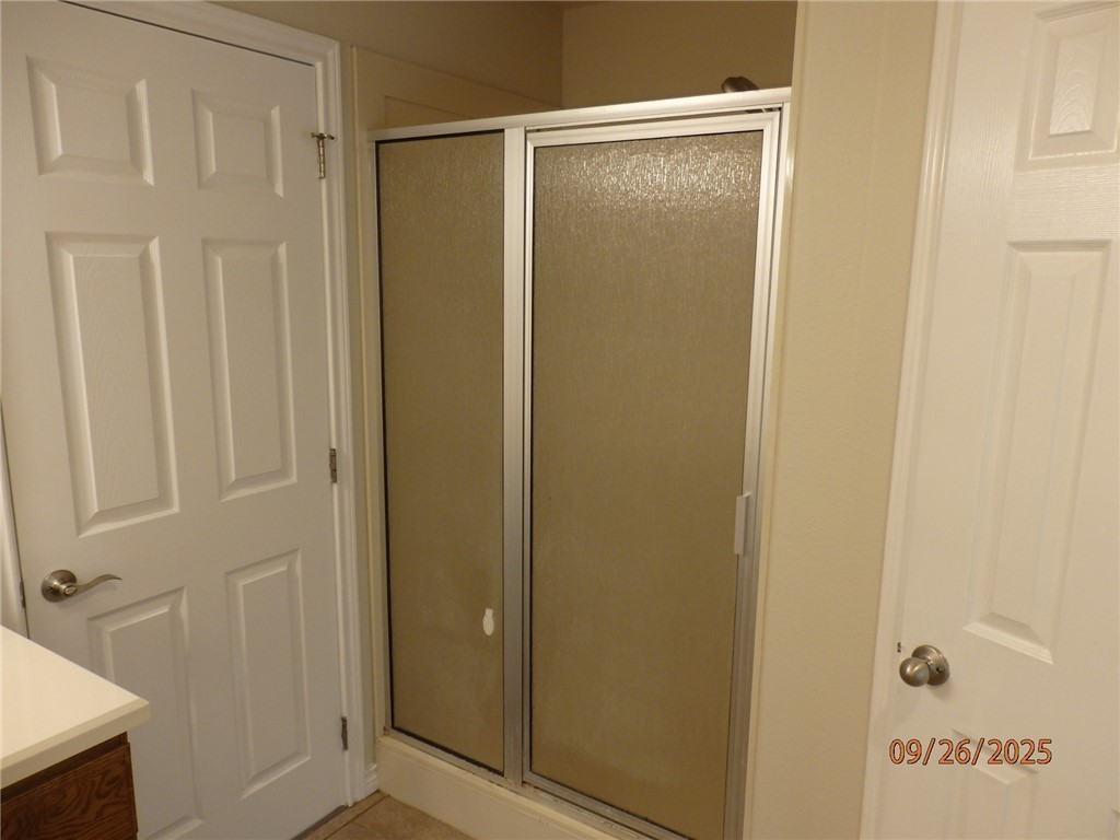 3717 Dove Crossing Lane College Station, TX 77845 - Photo 12 of 27 Full bathroom with a stall shower, vanity, and light tile patterned floors