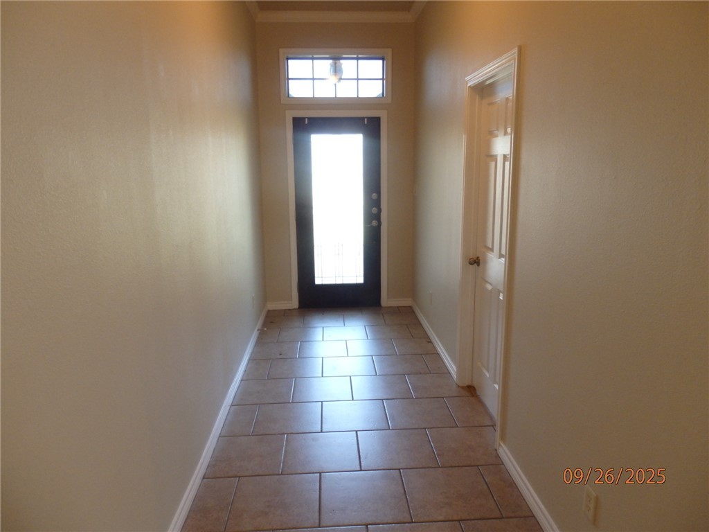 3717 Dove Crossing Lane College Station, TX 77845 - Photo 2 of 27 Doorway featuring tile patterned floors and crown molding