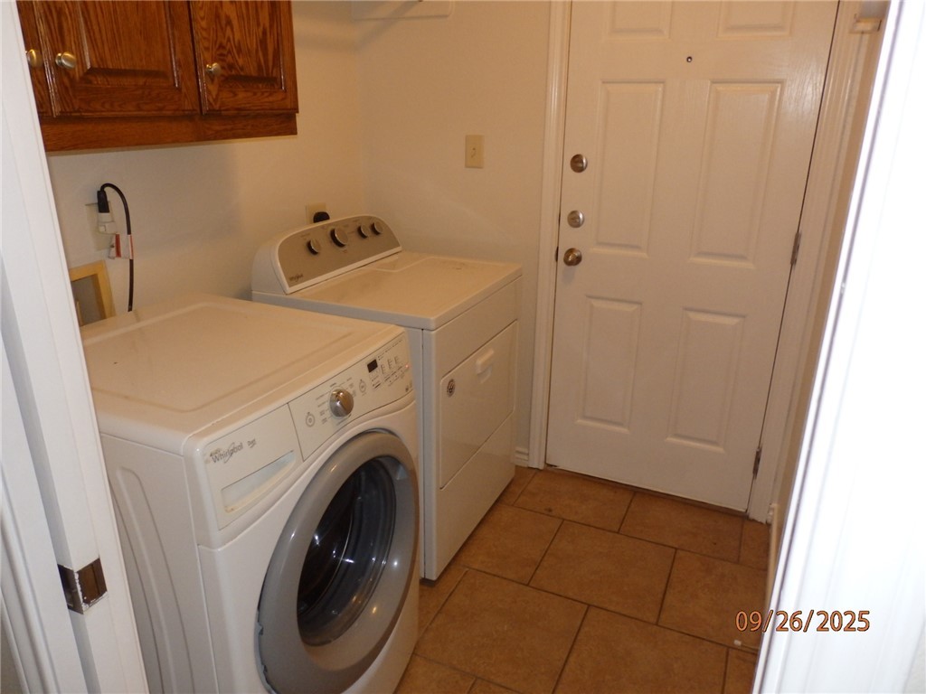 3717 Dove Crossing Lane College Station, TX 77845 - Photo 24 of 27 Washroom with light tile patterned floors, cabinet space, and independent washer and dryer