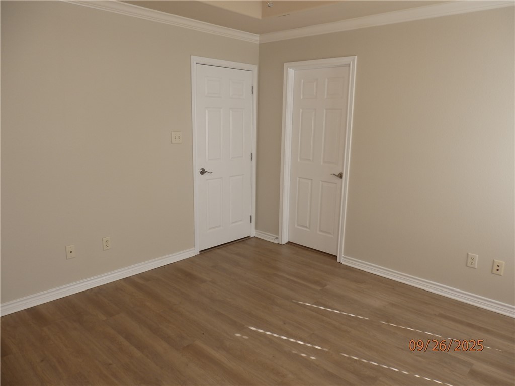 3717 Dove Crossing Lane College Station, TX 77845 - Photo 10 of 27 Empty room with crown molding and wood finished floors