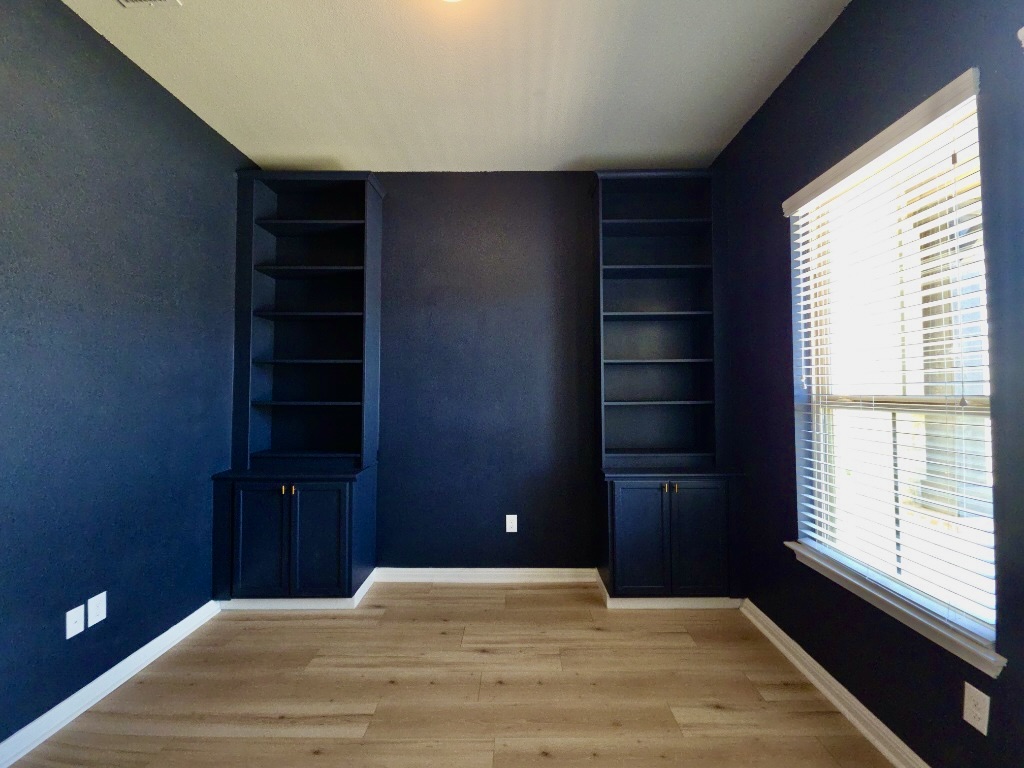 13208 Mariscan Street Manchaca, TX 78652 - Photo 18 of 31 Bedroom with built in shelves and light wood-style flooring