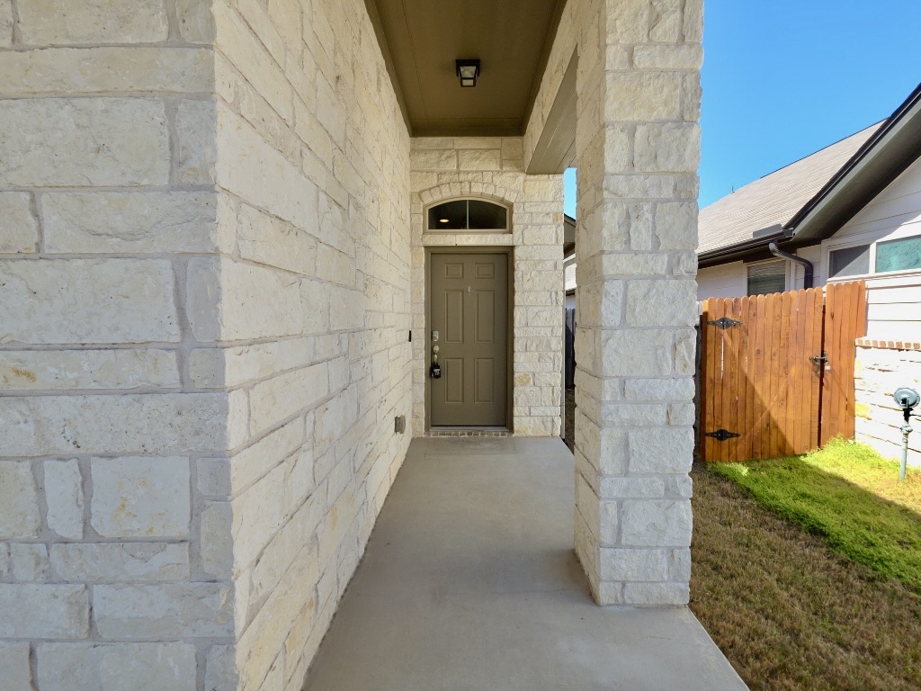 13208 Mariscan Street Manchaca, TX 78652 - Photo 2 of 31 Entrance to property featuring stone siding and a gate