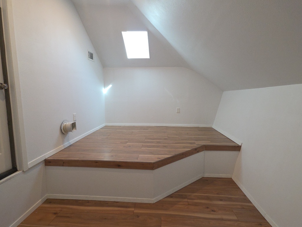 13208 Mariscan Street Manchaca, TX 78652 - Photo 26 of 31 Additional living space featuring dark wood-style floors and vaulted ceiling