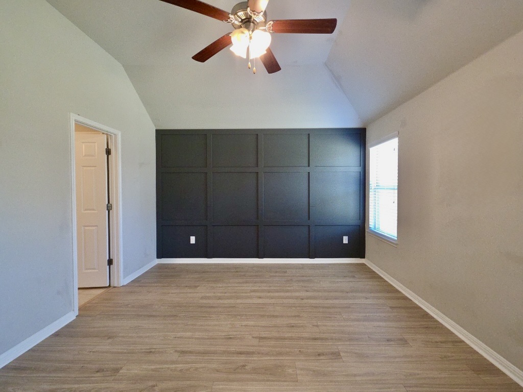 13208 Mariscan Street Manchaca, TX 78652 - Photo 10 of 31 Primary room with vaulted ceiling, wood finished floors, and a ceiling fan