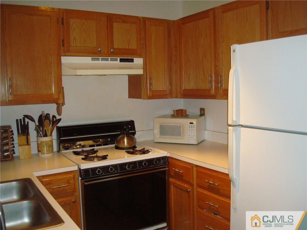 317 Edpas Road, Unit 317 New Brunswick, NJ 08901 - Photo 3 of 9 a kitchen with a stove and a refrigerator