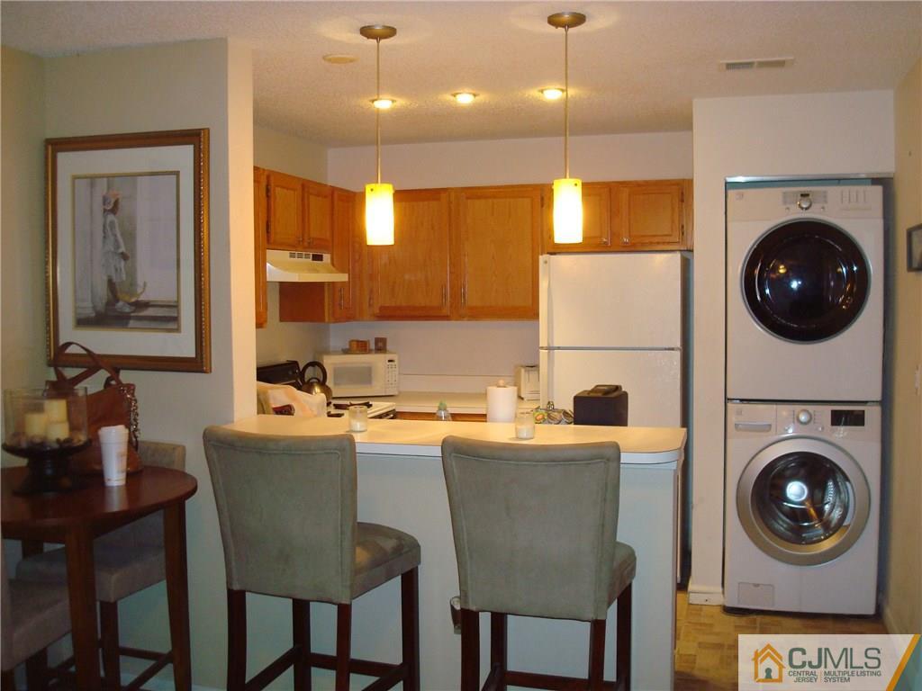 317 Edpas Road, Unit 317 New Brunswick, NJ 08901 - Photo 4 of 9 a kitchen with a sink a stove and a refrigerator