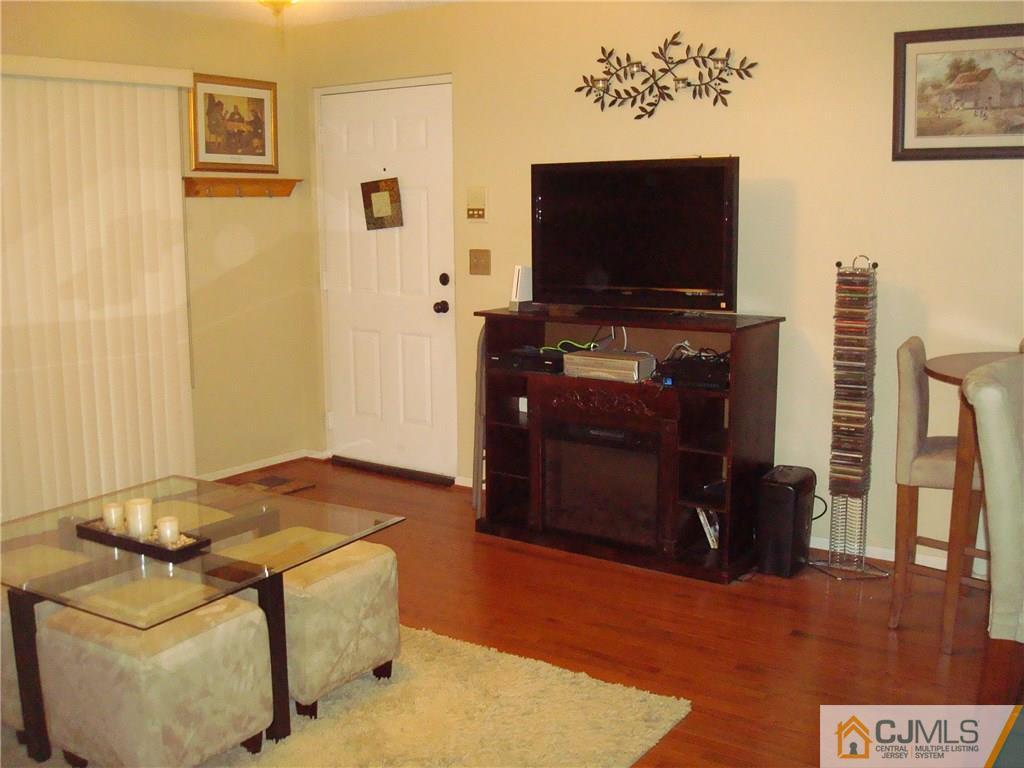 317 Edpas Road, Unit 317 New Brunswick, NJ 08901 - Photo 5 of 9 a living room with furniture and a flat screen tv